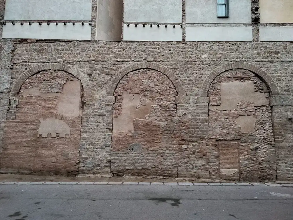 Roman aqueduct arches in the wall of a house