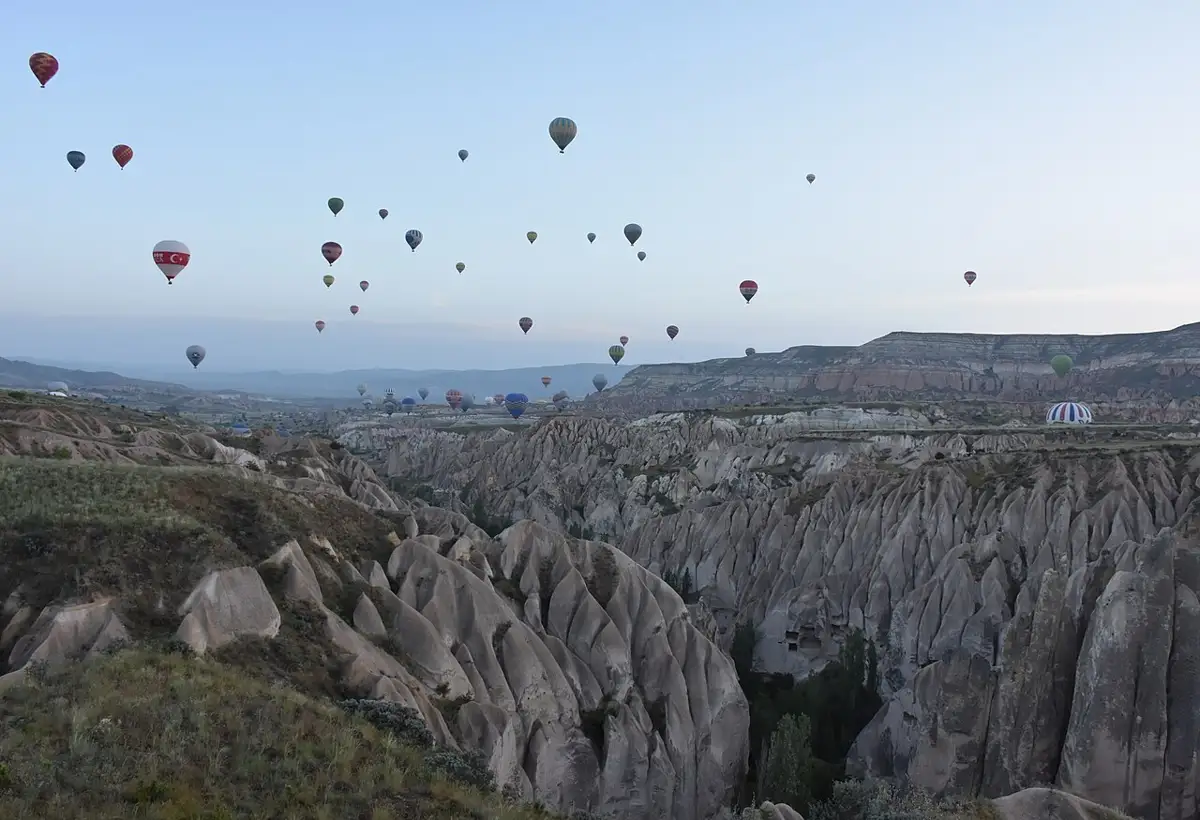 Hot air balloons at dawn over the valleys near Göreme
